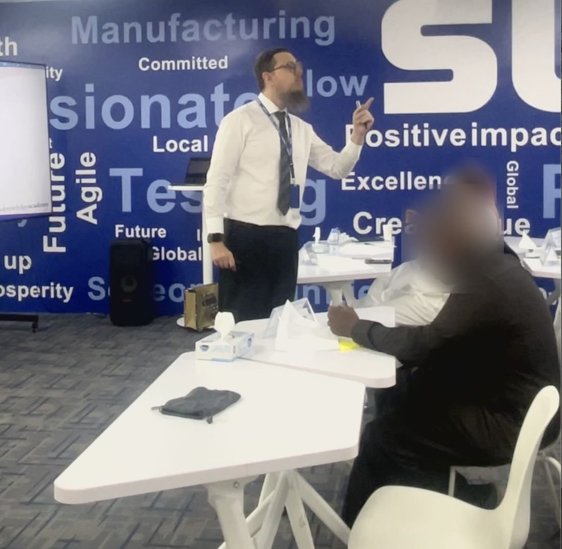 Julien presenting to a group of trainees